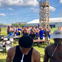 Football team lines up to get food from Alumni cooks